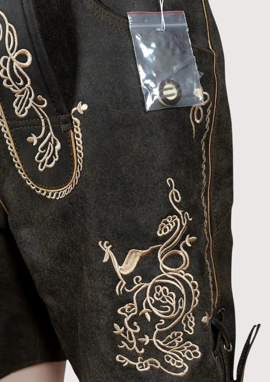Men’s embroidered lederhosen shorts with leather braces, decorative stitching, premium dark finish, and traditional Oktoberfest styling.