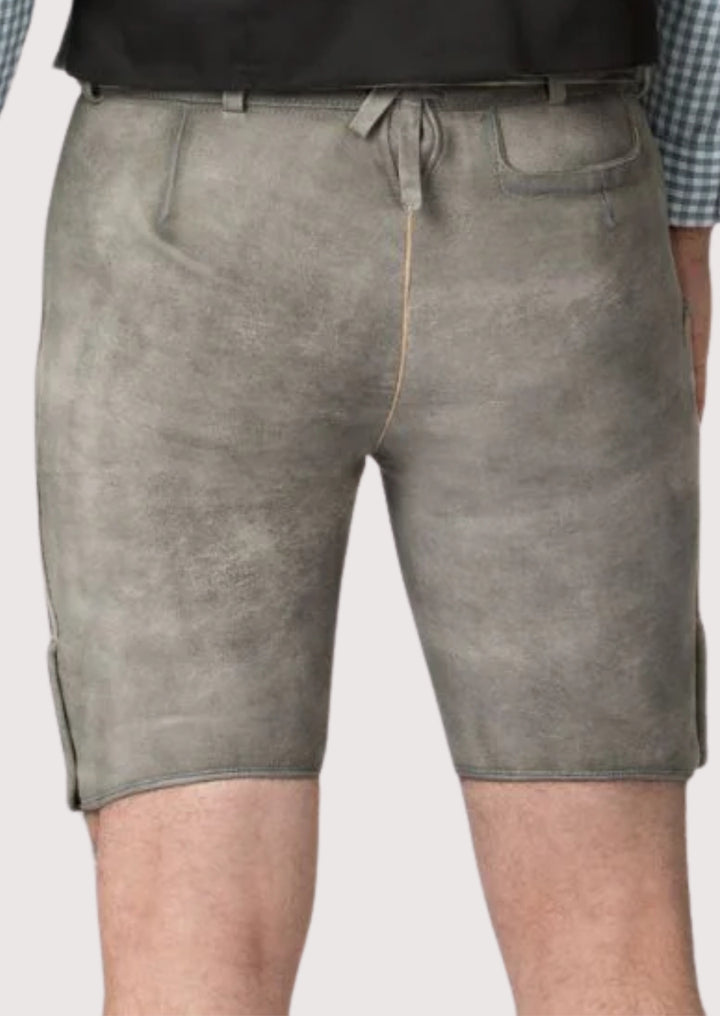 Authentic grey lederhosen featuring folk embroidery and leather texture