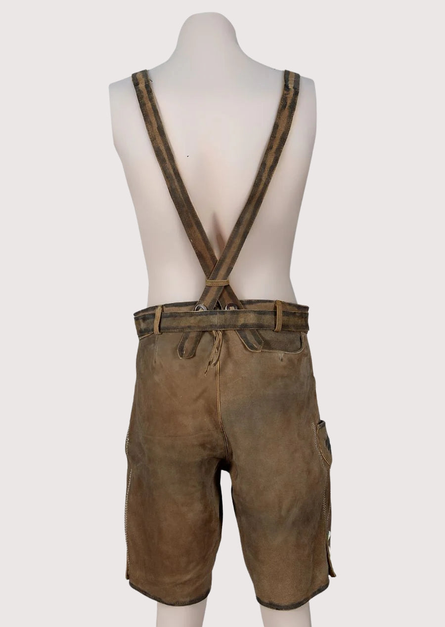 Classic embroidered lederhosen with braces crafted from brown leather, showcasing traditional German heritage fashion.
