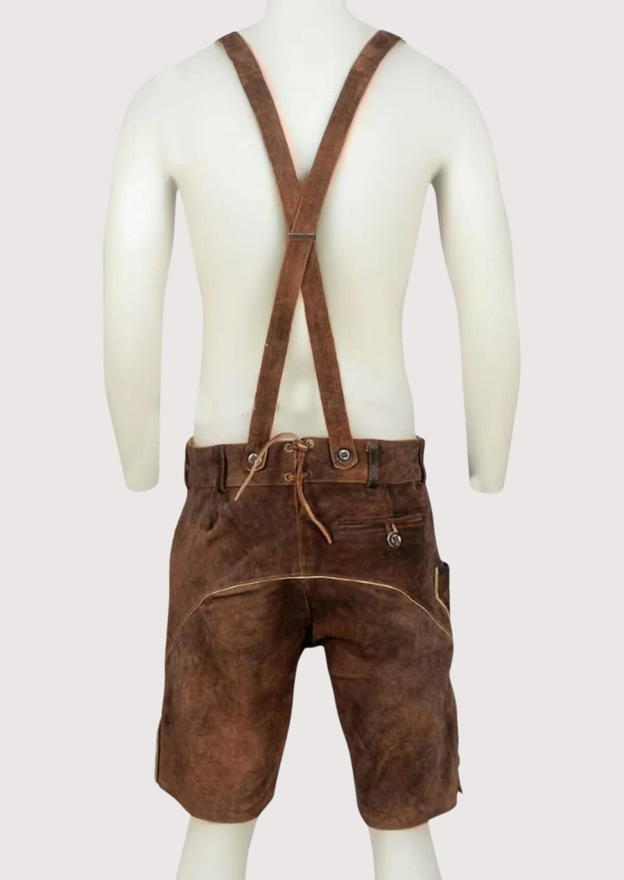 Classic men’s lederhosen shorts in brown leather with ornate embroidery and traditional Alpine craftsmanship.