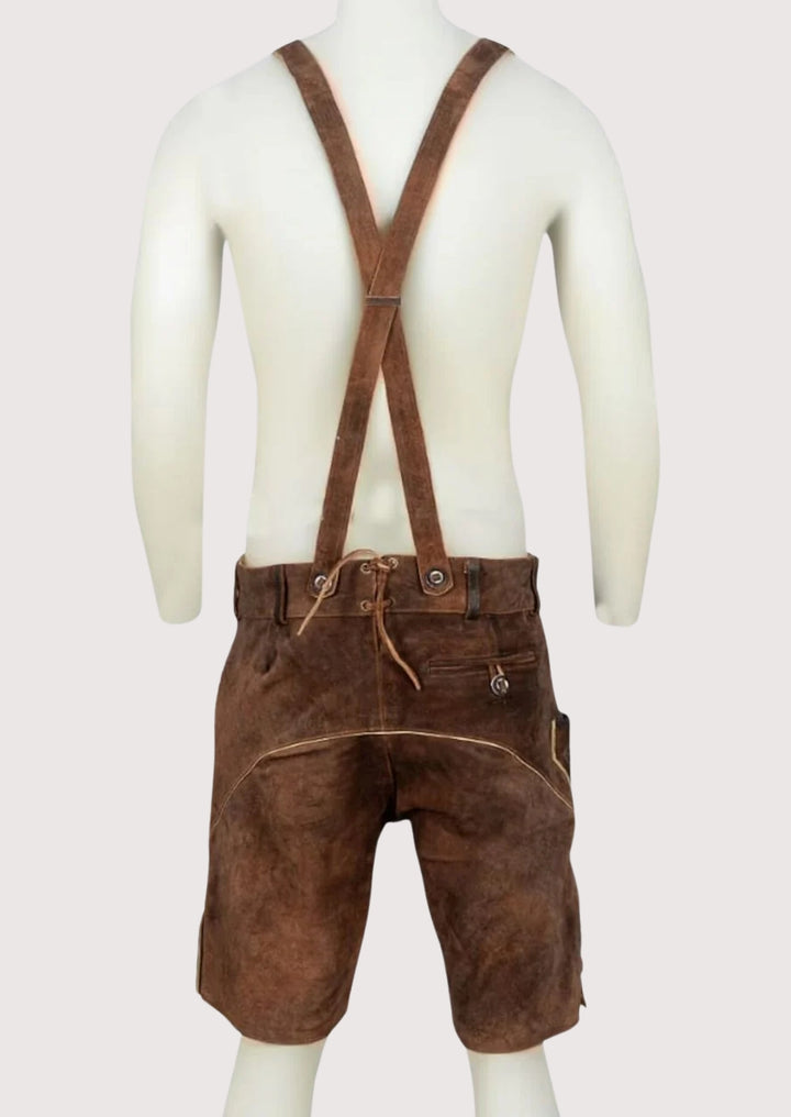 Classic men’s lederhosen shorts in brown leather with ornate embroidery and traditional Alpine craftsmanship.