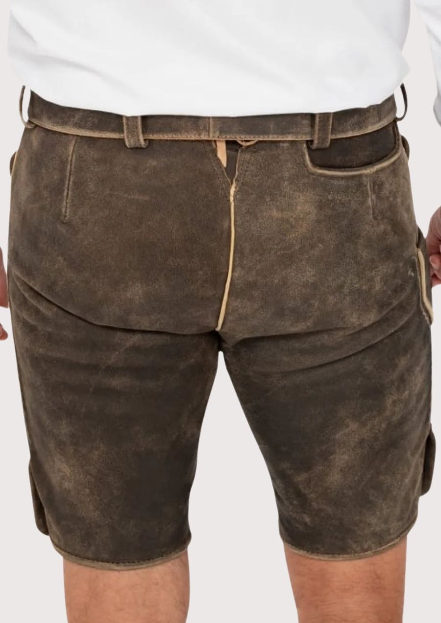 Oktoberfest outfit 2025 – Traditional men's lederhosen with intricate green stitching

