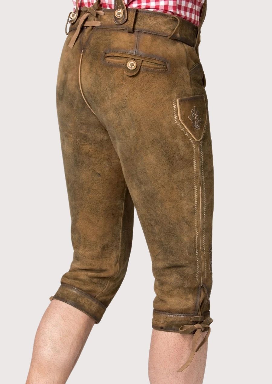 Timeless men's Bundhosen made from premium leather, featuring hand-stitched details and adjustable cuffs, providing warmth and style for winter outings.