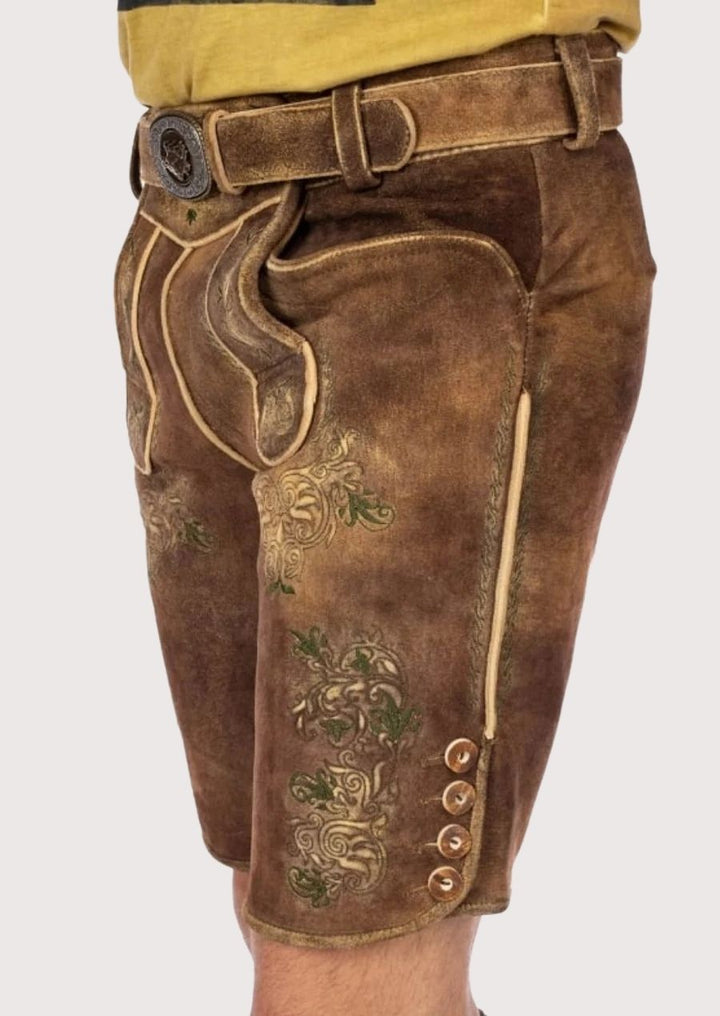 Premium leather men’s Lederhosen featuring detailed green floral embroidery, perfect for Bavarian celebrations and Oktoberfest.