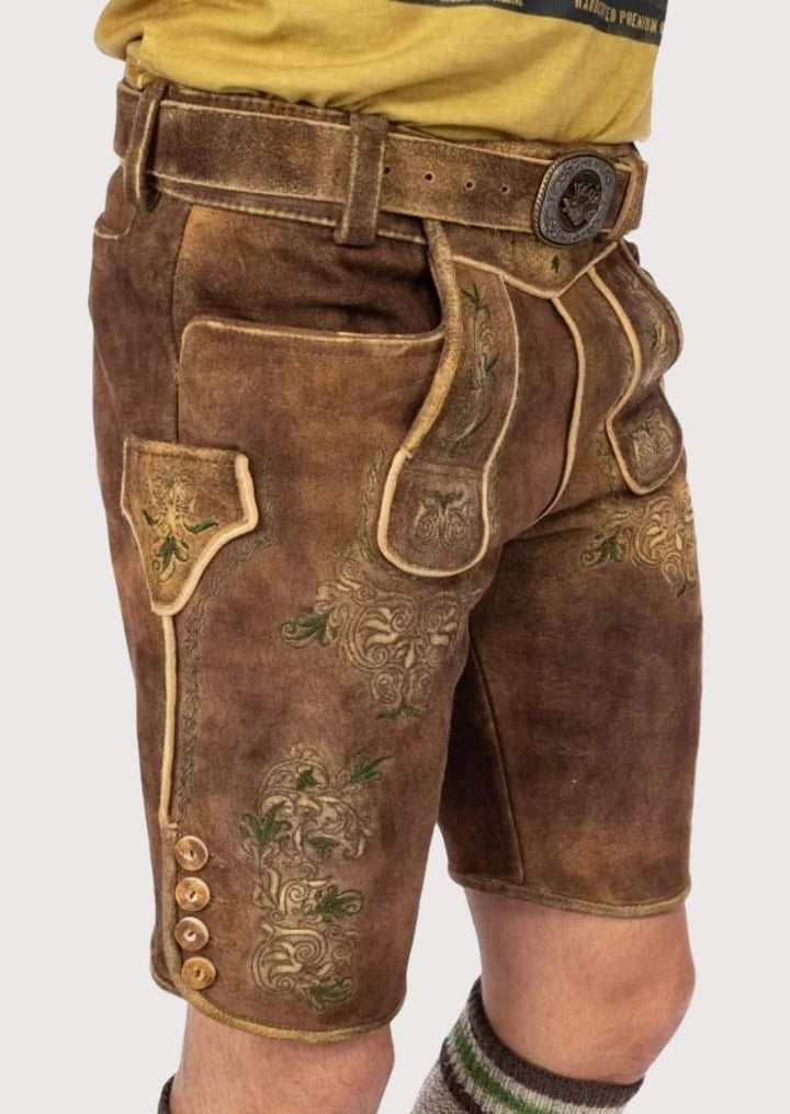 Men’s premium Lederhosen with green floral detailing and durable leather, designed for cultural events and Oktoberfest.