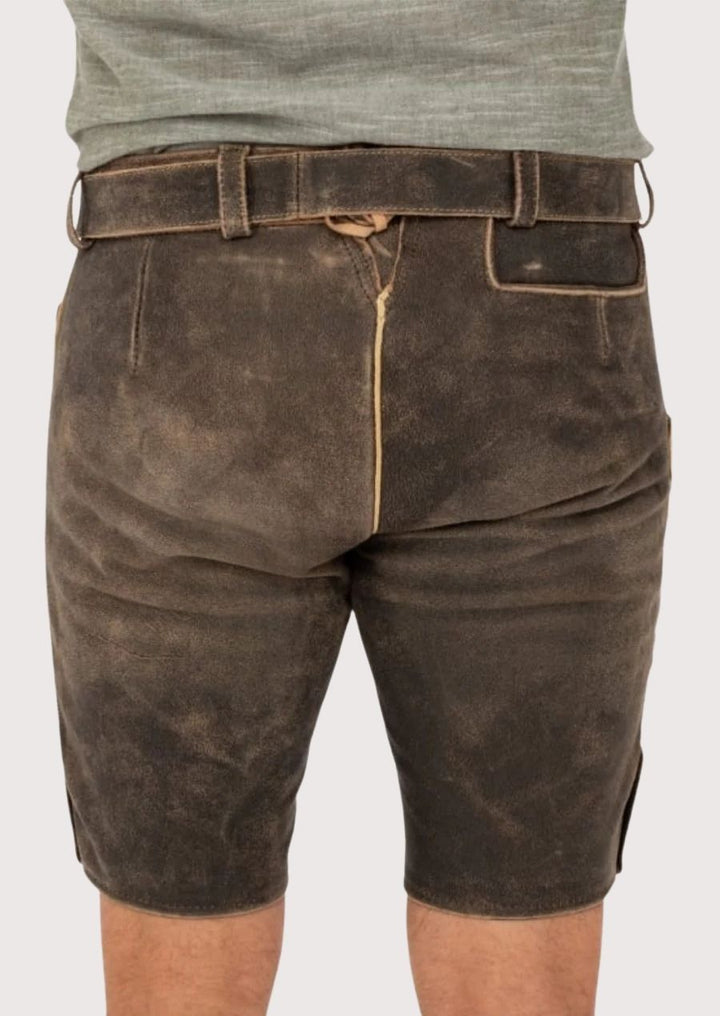 Men’s lederhosen featuring gold embroidery and durable leather, perfect for traditional festivals like Oktoberfest.