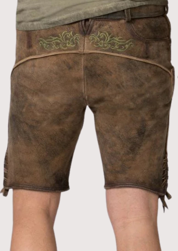 Traditional brown lederhosen shorts showing green stitched Bavarian decorative patterns