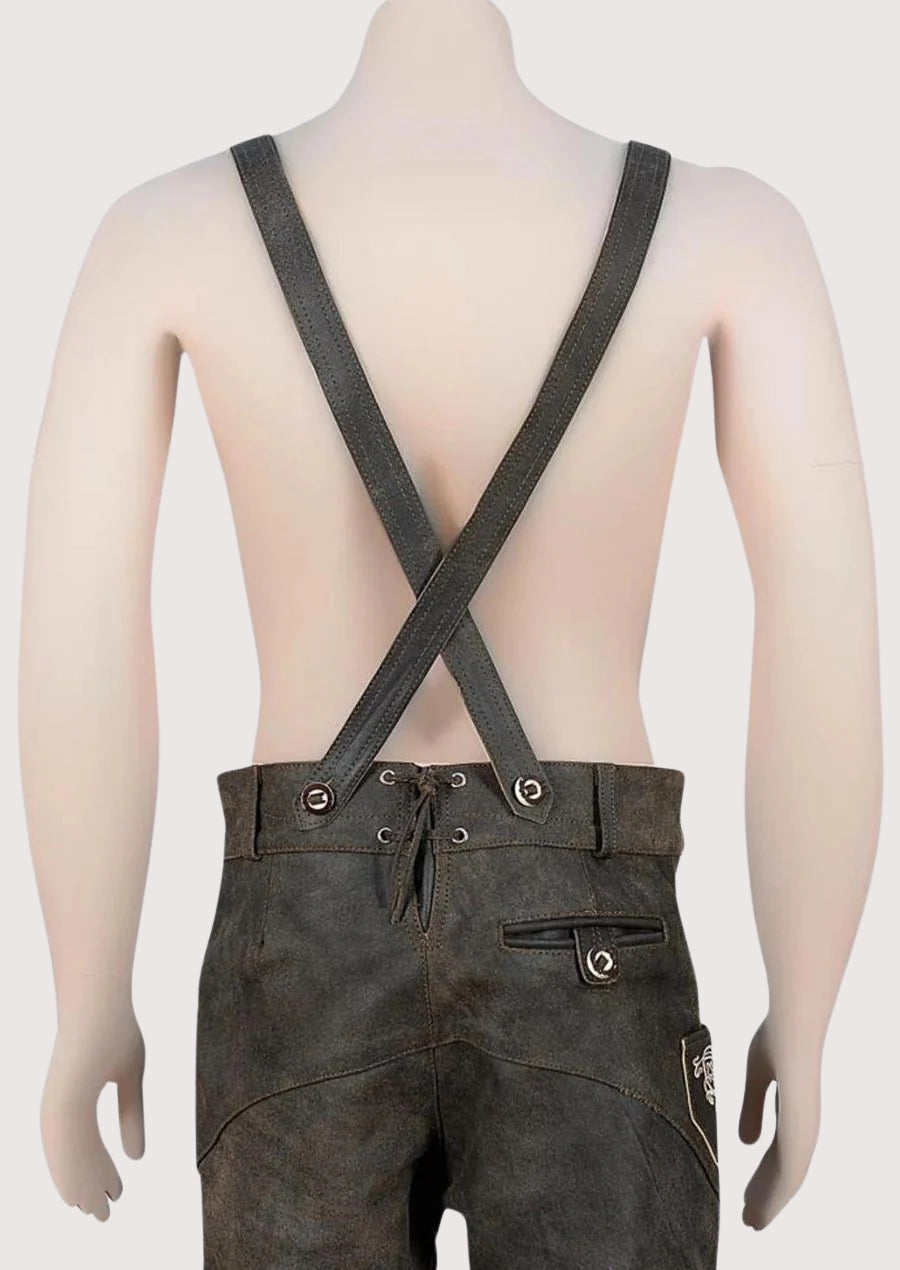 Authentic Alpine dark leather lederhosen with suspenders, detailed embroidery, heritage craftsmanship, and classic festival look.