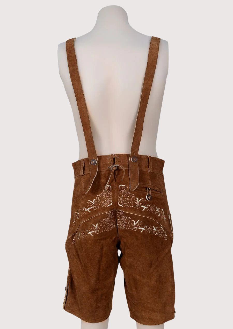 Vintage brown Bavarian lederhosen with decorative embroidery and suspenders, classic Oktoberfest clothing style.